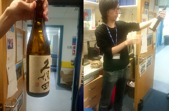 Yasunori Noguchi uncaps a bottle of sake to celebrate his new paper.